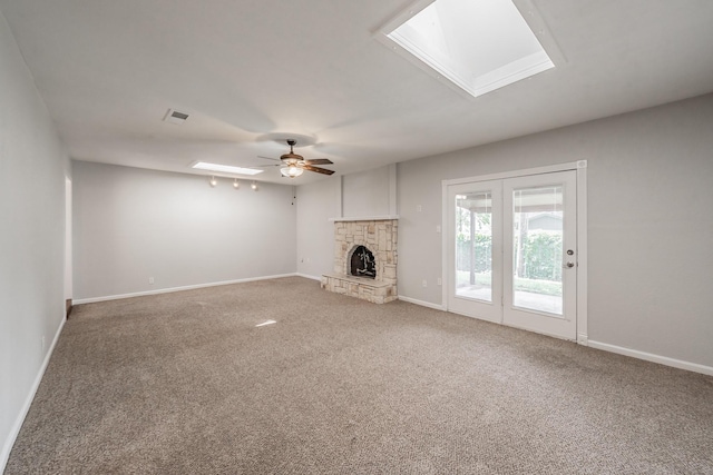 708 Simpson Ter, Bedford, TX 76021 - unfurnished living room featuring a skylight, light colored carpet, baseboards, and a ceiling fan