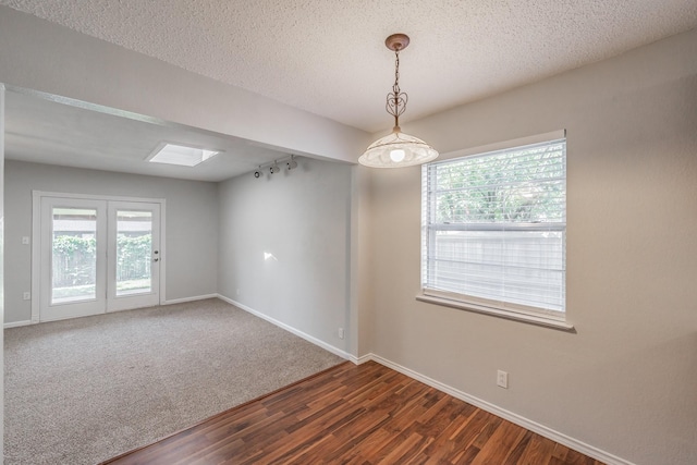 708 Simpson Ter, Bedford, TX 76021 - empty room featuring wood finished floors, baseboards, and a textured ceiling