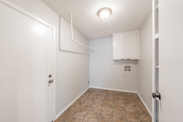 708 Simpson Ter, Bedford, TX 76021 - laundry area featuring cabinet space, washer hookup, a textured ceiling, and baseboards