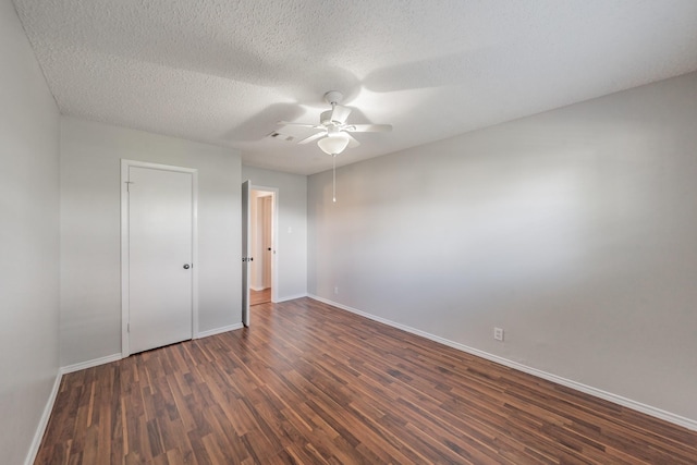 708 Simpson Ter, Bedford, TX 76021 - unfurnished bedroom with dark wood-style flooring, baseboards, a textured ceiling, and ceiling fan