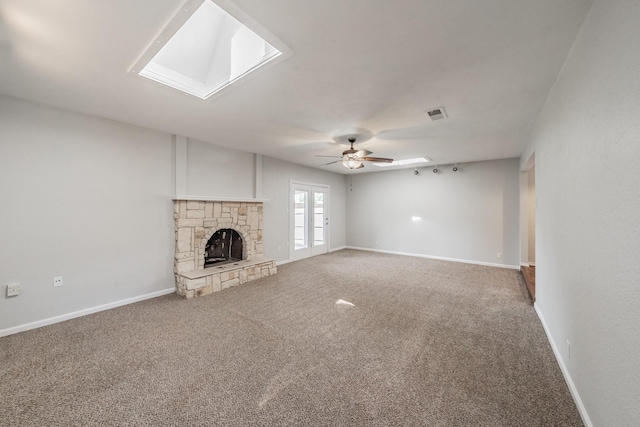 708 Simpson Ter, Bedford, TX 76021 - unfurnished living room with a skylight, carpet floors, ceiling fan, and a fireplace