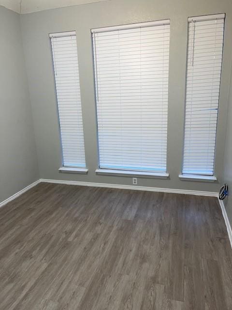 704 Kelsie Ln, Desoto, TX 75115 - spare room with dark wood-style flooring and baseboards