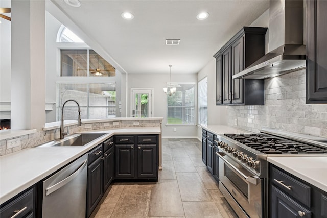 2210 Garden Crest Dr, Rockwall, TX 75087 - kitchen featuring wall chimney range hood, stainless steel appliances, tasteful backsplash, light countertops, and recessed lighting