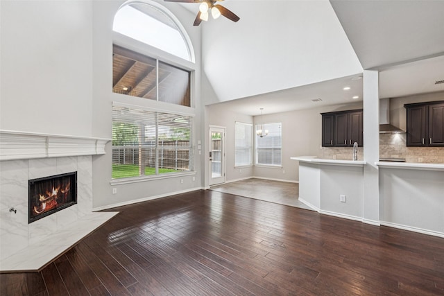 2210 Garden Crest Dr, Rockwall, TX 75087 - unfurnished living room featuring plenty of natural light, ceiling fan, a high end fireplace, hardwood / wood-style flooring, and a high ceiling