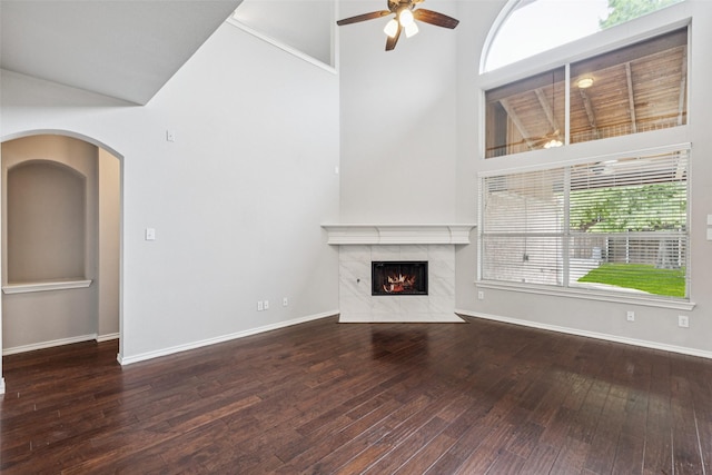 2210 Garden Crest Dr, Rockwall, TX 75087 - unfurnished living room with ceiling fan, a premium fireplace, wood-type flooring, high vaulted ceiling, and arched walkways