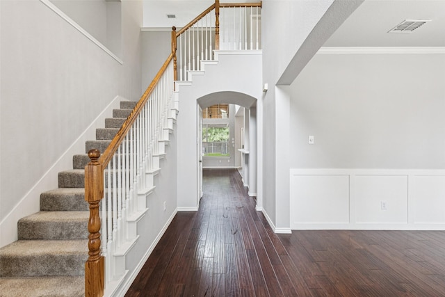 2210 Garden Crest Dr, Rockwall, TX 75087 - entryway featuring arched walkways, hardwood / wood-style floors, ornamental molding, and stairs