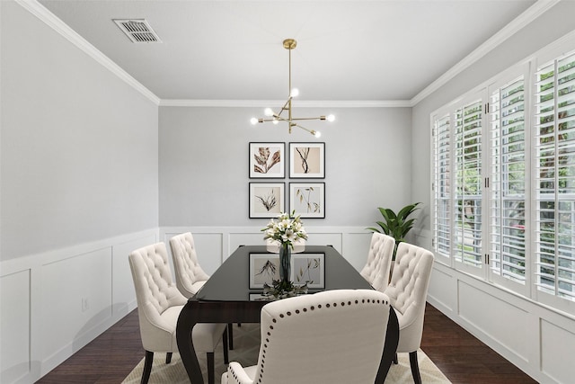 2210 Garden Crest Dr, Rockwall, TX 75087 - dining space featuring a chandelier, healthy amount of natural light, wood finished floors, crown molding, and a decorative wall