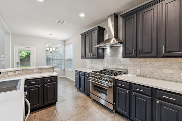 2210 Garden Crest Dr, Rockwall, TX 75087 - kitchen featuring wall chimney exhaust hood, high end range, decorative backsplash, a chandelier, and light countertops