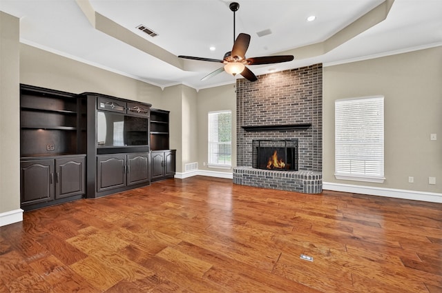 688 Lazy Acres Cir, Pottsboro, TX 75076 - unfurnished living room featuring ceiling fan, a tray ceiling, wood finished floors, ornamental molding, and recessed lighting