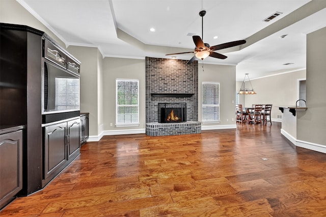 688 Lazy Acres Cir, Pottsboro, TX 75076 - living area featuring ceiling fan, wood finished floors, a brick fireplace, crown molding, and baseboards