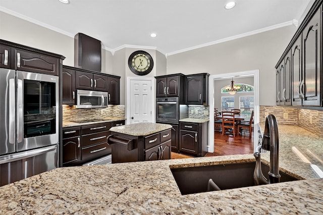 688 Lazy Acres Cir, Pottsboro, TX 75076 - kitchen featuring fridge, stainless steel microwave, a sink, ornamental molding, and tasteful backsplash