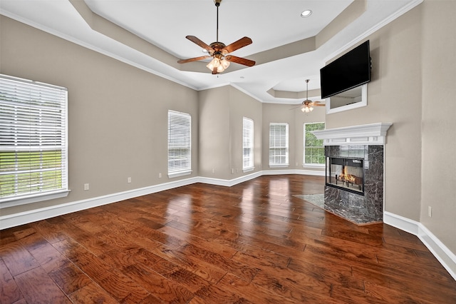 688 Lazy Acres Cir, Pottsboro, TX 75076 - unfurnished living room with ceiling fan, a raised ceiling, a high end fireplace, baseboards, and wood-type flooring