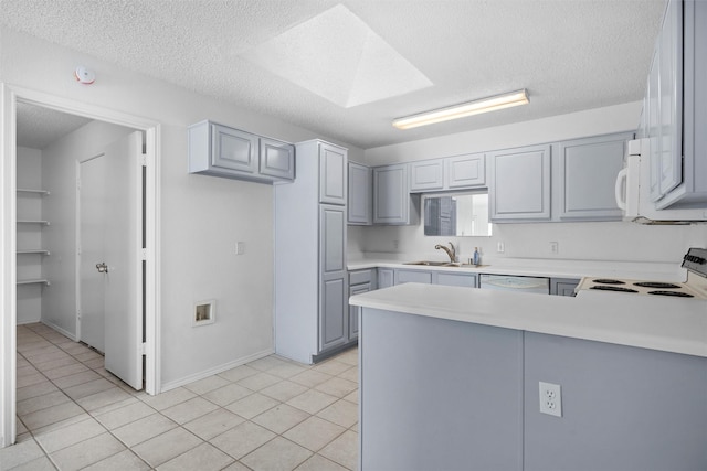 10228 Maverick Dr, Fort Worth, TX 76108 - kitchen featuring gray cabinets, white appliances, a textured ceiling, a peninsula, and light countertops