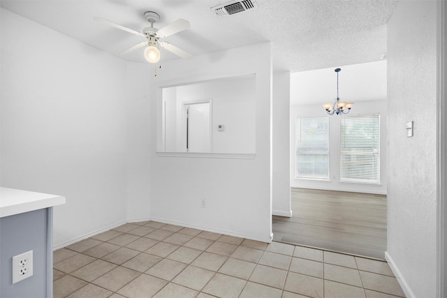 10228 Maverick Dr, Fort Worth, TX 76108 - spare room with a chandelier, light tile patterned floors, and ceiling fan