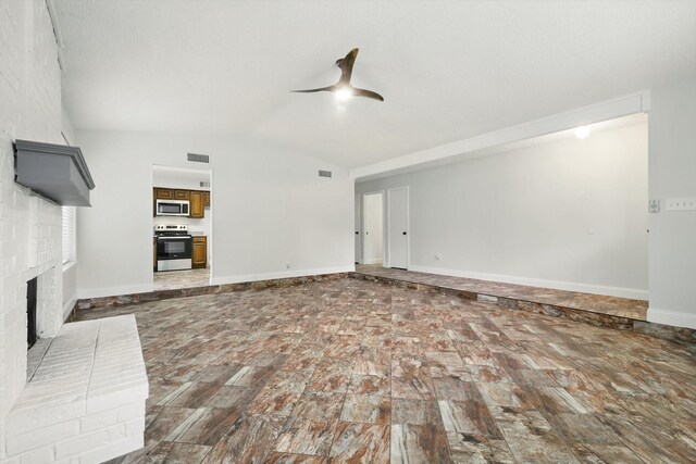 3217 Redwood St, Bedford, TX 76021 - unfurnished living room with ceiling fan, a brick fireplace, lofted ceiling, and baseboards