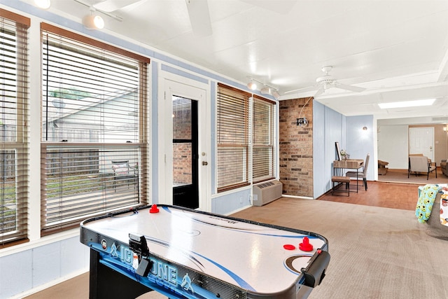 1305 Jabbet Dr, Plano, TX 75025 - game room with a ceiling fan, brick wall, and wood finished floors