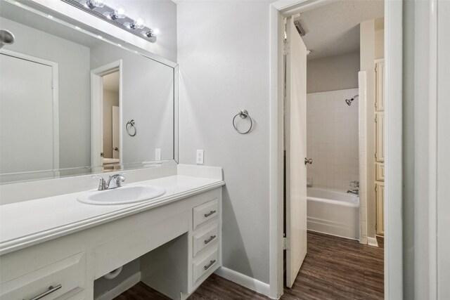 2201 Briarwood Blvd, Arlington, TX 76013 - full bath featuring wood finished floors, vanity, and shower / bath combination
