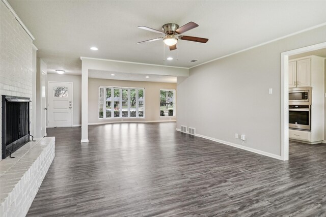 2201 Briarwood Blvd, Arlington, TX 76013 - unfurnished living room featuring dark wood-style flooring, ceiling fan, a fireplace, recessed lighting, and crown molding