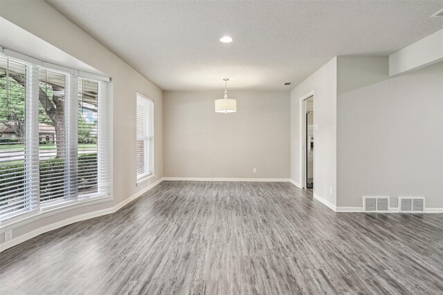 2201 Briarwood Blvd, Arlington, TX 76013 - unfurnished room featuring wood finished floors, a textured ceiling, and recessed lighting