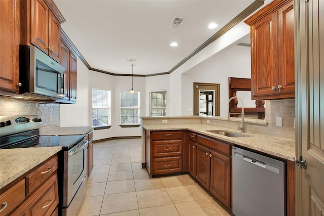 2111 Renaissance Dr, Denison, TX 75020 - kitchen featuring appliances with stainless steel finishes, a sink, light tile patterned floors, a peninsula, and crown molding