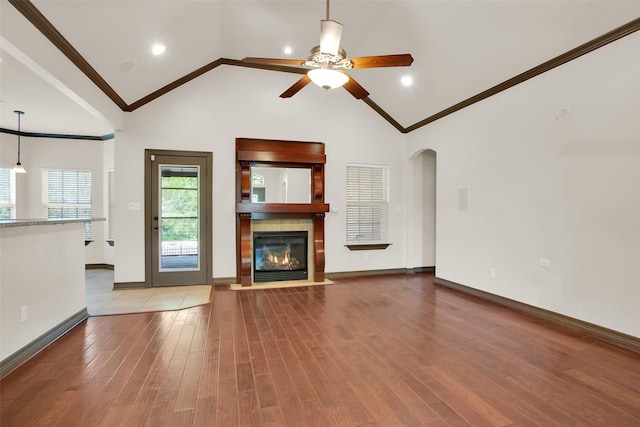 2111 Renaissance Dr, Denison, TX 75020 - unfurnished living room with ornamental molding, ceiling fan, wood finished floors, arched walkways, and baseboards