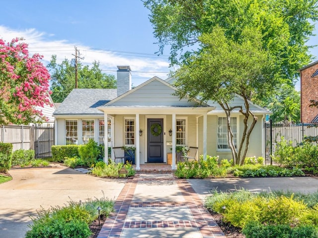 4604 Southern Ave, Highland Park, TX 75209 - bungalow-style house with covered porch and a chimney