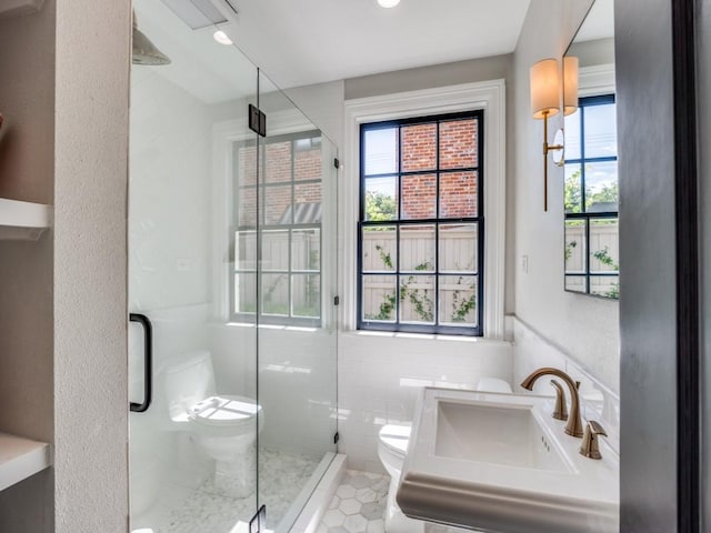 4604 Southern Ave, Highland Park, TX 75209 - full bath with toilet, a stall shower, healthy amount of natural light, a sink, and tile walls