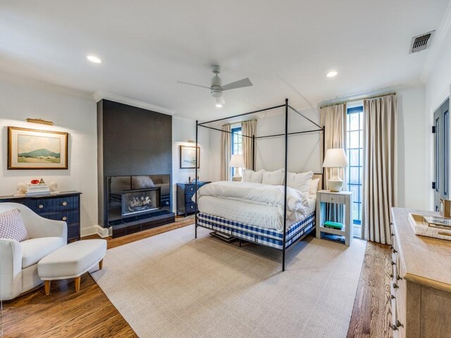 4604 Southern Ave, Highland Park, TX 75209 - bedroom with light wood finished floors, recessed lighting, a ceiling fan, and a large fireplace