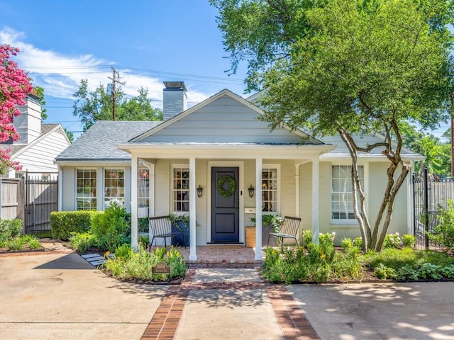 4604 Southern Ave, Highland Park, TX 75209 - bungalow-style house with a porch and a chimney