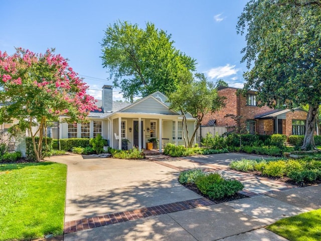 4604 Southern Ave, Highland Park, TX 75209 - view of front of house with covered porch, a chimney, and a front lawn