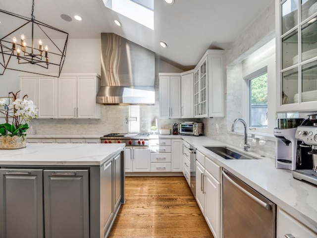 4604 Southern Ave, Highland Park, TX 75209 - kitchen featuring wall chimney range hood, appliances with stainless steel finishes, a sink, vaulted ceiling, and white cabinets