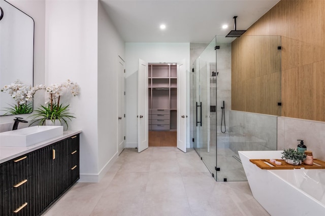4322 Sexton Ln, Dallas, TX 75229 - bathroom featuring a stall shower, vanity, a freestanding bath, a spacious closet, and recessed lighting