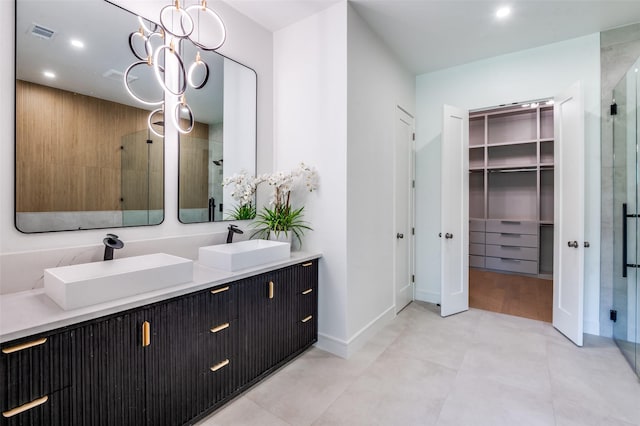 4322 Sexton Ln, Dallas, TX 75229 - bathroom with a shower stall, double vanity, a spacious closet, recessed lighting, and baseboards