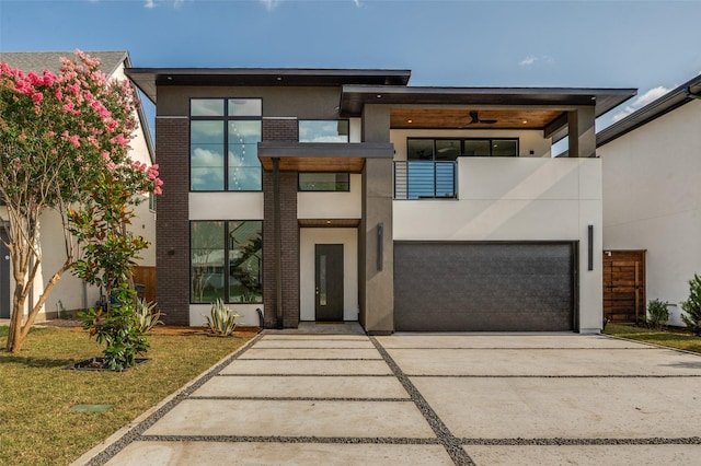 4322 Sexton Ln, Dallas, TX 75229 - contemporary house featuring a garage, driveway, stucco siding, a balcony, and brick siding