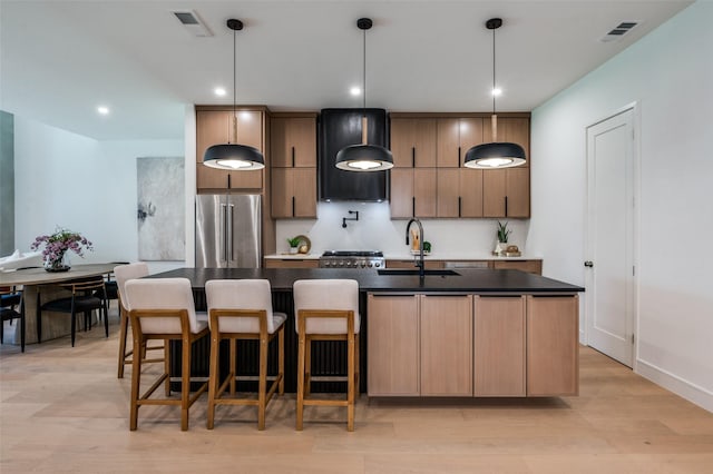 4322 Sexton Ln, Dallas, TX 75229 - kitchen with high end fridge, a sink, custom range hood, a center island with sink, and dark countertops