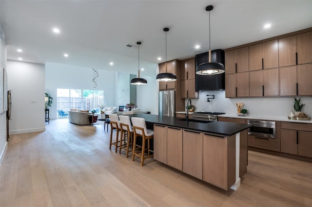 4322 Sexton Ln, Dallas, TX 75229 - kitchen with stainless steel appliances, custom exhaust hood, a sink, light wood finished floors, and recessed lighting
