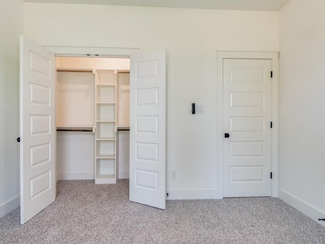6434 Abner Rd, Terrell, TX 75161 - unfurnished bedroom featuring carpet flooring, a closet, and baseboards