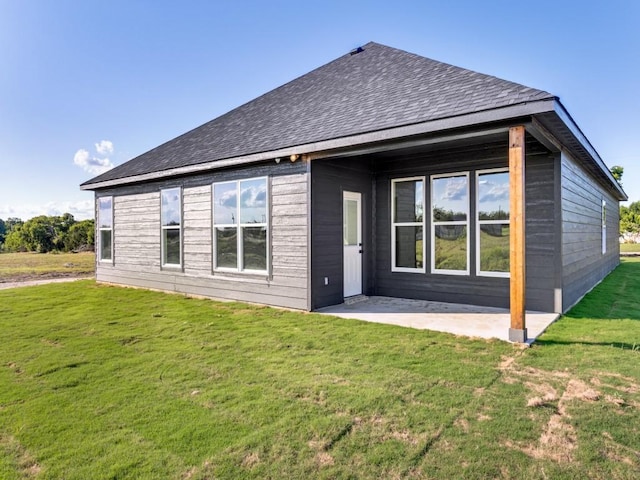 6434 Abner Rd, Terrell, TX 75161 - rear view of house with a patio area, a lawn, and roof with shingles