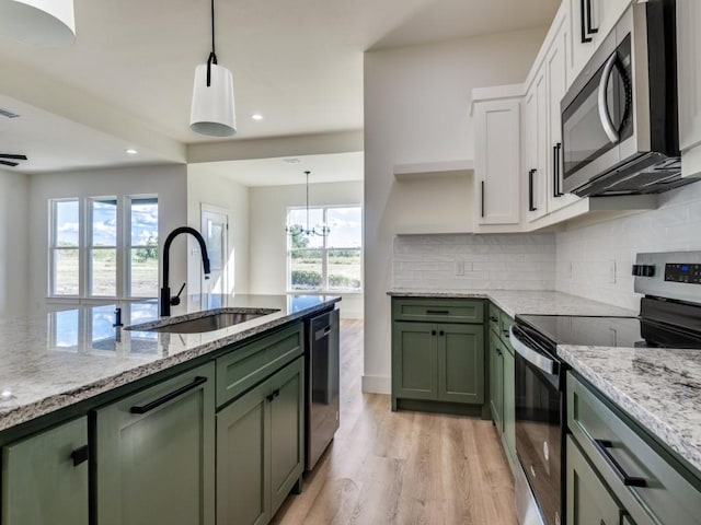 6434 Abner Rd, Terrell, TX 75161 - kitchen with green cabinetry, stainless steel appliances, a sink, white cabinetry, and recessed lighting