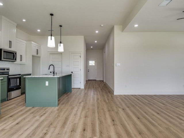 6434 Abner Rd, Terrell, TX 75161 - kitchen with stainless steel appliances, light wood-style floors, open floor plan, recessed lighting, and decorative backsplash