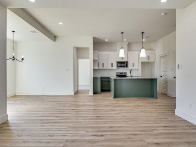 6434 Abner Rd, Terrell, TX 75161 - kitchen with stainless steel microwave, range with electric cooktop, light wood-type flooring, a chandelier, and recessed lighting