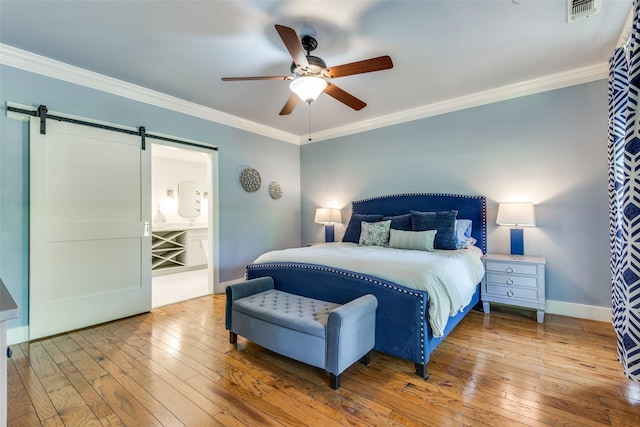 711 Majestic Oaks Dr, Oak Point, TX 75068 - bedroom featuring a barn door, hardwood / wood-style flooring, crown molding, a ceiling fan, and ensuite bathroom