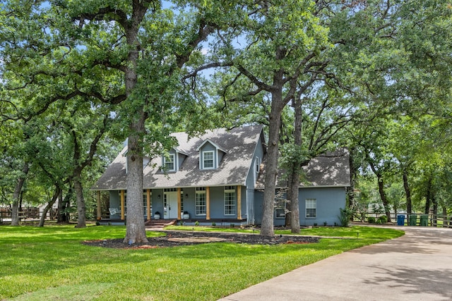 711 Majestic Oaks Dr, Oak Point, TX 75068 - cape cod home featuring covered porch, a front lawn, and roof with shingles