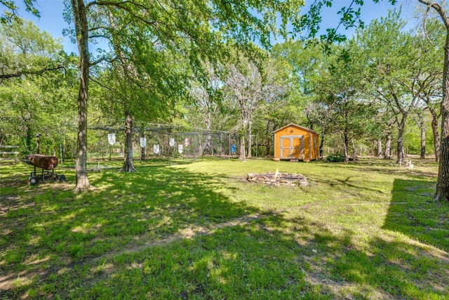 711 Majestic Oaks Dr, Oak Point, TX 75068 - view of green lawn featuring a storage unit and a fire pit