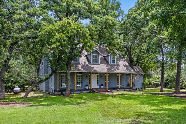 711 Majestic Oaks Dr, Oak Point, TX 75068 - cape cod house featuring covered porch and a front yard