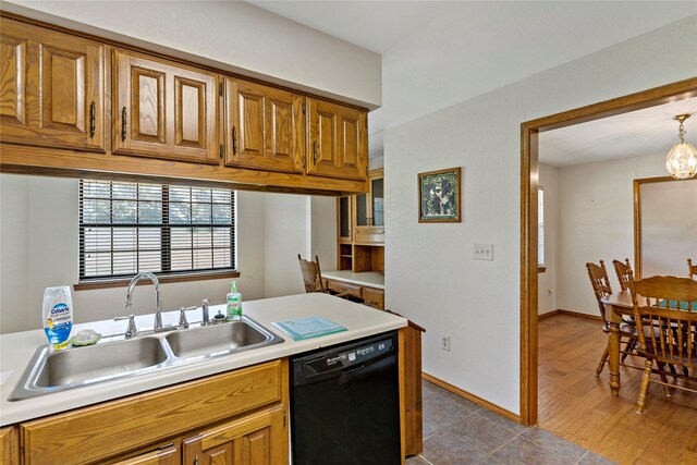 4395 Farm Rd Unit 2820, Sumner, TX 75486 - kitchen featuring dishwasher, a sink, light countertops, brown cabinetry, and a chandelier