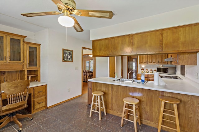 4395 Farm Rd Unit 2820, Sumner, TX 75486 - kitchen with appliances with stainless steel finishes, brown cabinetry, a peninsula, and light countertops