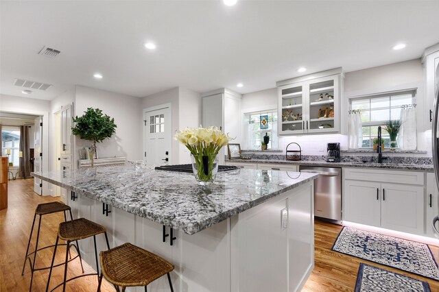 1405 N Wharton St, Sherman, TX 75092 - kitchen with stainless steel appliances, a sink, plenty of natural light, light stone counters, and recessed lighting