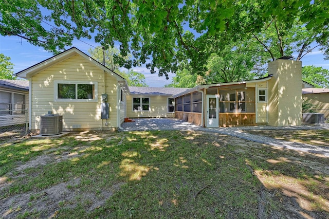 1405 N Wharton St, Sherman, TX 75092 - rear view of house with a sunroom, cooling unit, and a lawn