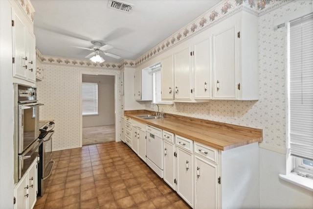 1506 Ridgeview Dr, Arlington, TX 76012 - kitchen featuring wallpapered walls, white dishwasher, oven, a sink, and ceiling fan